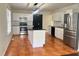 Modern kitchen with white cabinets, stainless steel appliances, and a central island at 1418 Brookside Manor Ct, Tucker, GA 30084