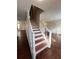 Elegant staircase with hardwood steps and white railing at 1418 Brookside Manor Ct, Tucker, GA 30084