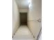 View of a stairway leading down, featuring white painted steps and a matching handrail, creating a clean and minimalist aesthetic at 1418 Brookside Manor Ct, Tucker, GA 30084