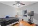 Bedroom with hardwood floors, ceiling fan, and a mirrored closet at 1641 Hedington Ct, Lawrenceville, GA 30045