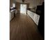 Long kitchen featuring white cabinetry, and black appliances at 2720 Sandy Creek Cir, Loganville, GA 30052