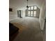 Bright living room featuring a fireplace, tall windows, and access to other rooms at 2720 Sandy Creek Cir, Loganville, GA 30052