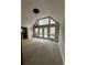 Bright living room with vaulted ceilings, large windows, chandelier, and access to an outdoor deck at 2720 Sandy Creek Cir, Loganville, GA 30052