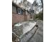 Back patio with brick accents and swing seating at 2720 Sandy Creek Cir, Loganville, GA 30052