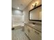 Bathroom with granite countertop, white cabinetry, and a shower-tub combo at 642 Presley Farm Pkwy, Rockmart, GA 30153