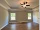 Bright, large bedroom with hardwood floors, tray ceilings, and two windows at 642 Presley Farm Pkwy, Rockmart, GA 30153