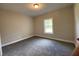 Cozy carpeted bedroom with natural light from window at 642 Presley Farm Pkwy, Rockmart, GA 30153