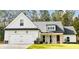 Beautiful exterior elevation with a mix of siding textures, stone accents, and a two-car garage at 642 Presley Farm Pkwy, Rockmart, GA 30153