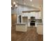 Bright kitchen features a central island, stainless appliances, and pendant lighting at 642 Presley Farm Pkwy, Rockmart, GA 30153