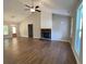 Spacious living room featuring a fireplace, modern lighting, and hardwood floors at 642 Presley Farm Pkwy, Rockmart, GA 30153