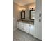 This bathroom features double sink vanity, granite countertop, modern fixtures and patterned floor at 642 Presley Farm Pkwy, Rockmart, GA 30153