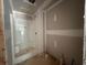 An unfinished bathroom shows a shower stall ready for finishing touches, highlighting its potential at 642 Presley Farm Pkwy, Rockmart, GA 30153