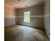 A bedroom shows the window and ceiling ready for finishing touches, highlighting its potential charm at 642 Presley Farm Pkwy, Rockmart, GA 30153
