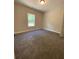 Bedroom with carpet, window for natural light and neutral paint at 642 Presley Farm Pkwy, Rockmart, GA 30153