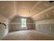 An unfinished bedroom featuring a large window and tray ceiling shows a well-lit space, highlighting its potential at 642 Presley Farm Pkwy, Rockmart, GA 30153