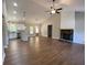 Open-concept living room with hardwood floors, stone fireplace, and modern lighting at 642 Presley Farm Pkwy, Rockmart, GA 30153