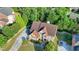 An aerial view showcases a brick two-story home with a driveway and a well-maintained lawn at 1755 Riverpark Dr, Dacula, GA 30019