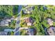 Aerial shot of a brick two-story home encircled in yellow, nestled in a neighborhood amidst lush greenery at 1755 Riverpark Dr, Dacula, GA 30019