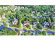 Aerial shot of a brick two-story home encircled in yellow, nestled in a neighborhood amidst lush greenery at 1755 Riverpark Dr, Dacula, GA 30019