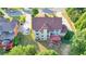 Aerial shot of backyard featuring a deck, well-maintained lawn, mature trees, and partial view of the home's exterior at 1755 Riverpark Dr, Dacula, GA 30019