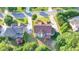 A high angle aerial view of a home with a deck and verdant backyard in a residential neighborhood at 1755 Riverpark Dr, Dacula, GA 30019