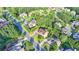 Aerial shot of a brick two-story home encircled in yellow, nestled in a neighborhood amidst lush greenery at 1755 Riverpark Dr, Dacula, GA 30019