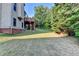 View of backyard featuring a deck with stairs and a large, grassy area bordered by trees at 1755 Riverpark Dr, Dacula, GA 30019