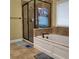 Modern bathroom featuring a glass-enclosed shower, soaking tub, and tile surround at 1755 Riverpark Dr, Dacula, GA 30019