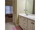 Bright bathroom featuring a white vanity with double sinks, a large mirror, and tile flooring at 1755 Riverpark Dr, Dacula, GA 30019