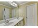 Well-lit bathroom featuring dual sinks, a large mirror, and crisp white doors and trim at 1755 Riverpark Dr, Dacula, GA 30019