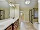 Bathroom featuring a double vanity, tile floor, walk-in shower and walk-in closet at 1755 Riverpark Dr, Dacula, GA 30019