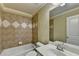 Bathroom with tile accents, bathtub, single sink vanity and framed mirror at 1755 Riverpark Dr, Dacula, GA 30019