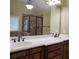 Bathroom featuring a double sink vanity with granite countertops and tile accents at 1755 Riverpark Dr, Dacula, GA 30019