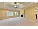 Large main bedroom showcasing fireplace, built-in shelves, and neutral carpet at 1755 Riverpark Dr, Dacula, GA 30019
