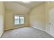 Neutral bedroom featuring carpet, a window, and a door that provides a blank canvas to personalize at 1755 Riverpark Dr, Dacula, GA 30019