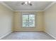 This bedroom has neutral carpet, a ceiling fan, and a window with natural light at 1755 Riverpark Dr, Dacula, GA 30019