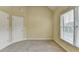 Neutral bedroom featuring carpet, a window with blinds, and a door that provides a blank canvas to personalize at 1755 Riverpark Dr, Dacula, GA 30019