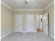 Bedroom with neutral carpet, ceiling fan, and a view of other rooms through open doors at 1755 Riverpark Dr, Dacula, GA 30019