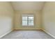 Neutral bedroom featuring carpet, a window, and a door that provides a blank canvas to personalize at 1755 Riverpark Dr, Dacula, GA 30019
