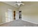 Bedroom boasts access to an adjacent bathroom, neutral carpeting and a ceiling fan at 1755 Riverpark Dr, Dacula, GA 30019