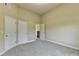 Neutral bedroom featuring carpet, multiple doors, and a window that provides a blank canvas to personalize at 1755 Riverpark Dr, Dacula, GA 30019