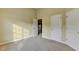 Neutral bedroom featuring carpet, multiple doors, and a window that provides a blank canvas to personalize at 1755 Riverpark Dr, Dacula, GA 30019