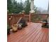 Outdoor wood deck with wood railing holding planted container pots with multiple plant specimens at 1755 Riverpark Dr, Dacula, GA 30019