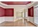 Spacious dining room with hardwood floors connecting to a carpeted living room space at 1755 Riverpark Dr, Dacula, GA 30019