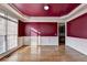 Dining room with hardwood floors, wainscoting, and a crimson-colored ceiling at 1755 Riverpark Dr, Dacula, GA 30019