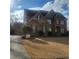 Beautiful two-story brick home with a well-manicured lawn and attached two-car garage at 1755 Riverpark Dr, Dacula, GA 30019