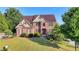 Beautiful brick two-story home with mature trees and a well-manicured front yard at 1755 Riverpark Dr, Dacula, GA 30019