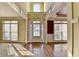 Bright foyer with gleaming hardwood floors, transom windows, and arched doorway at 1755 Riverpark Dr, Dacula, GA 30019