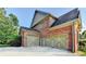 Spacious three-car garage with decorative doors and a wide driveway at 1755 Riverpark Dr, Dacula, GA 30019