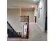 Upper-level hallway with carpet, wrought iron railing, and doorways leading to bedrooms at 1755 Riverpark Dr, Dacula, GA 30019